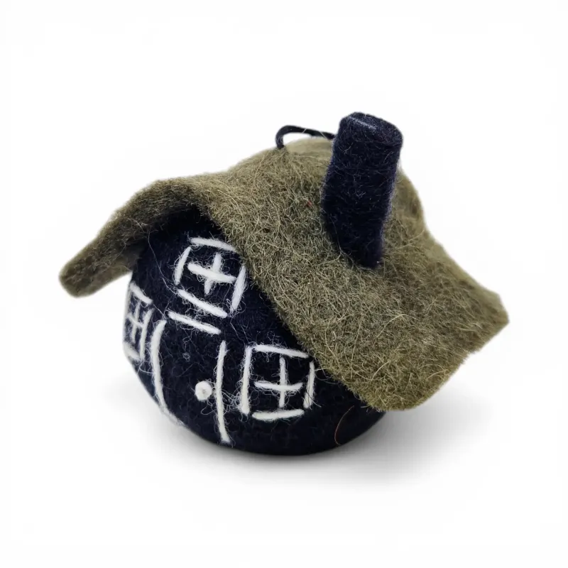 Left side view of handmade wool black Turf House Flóki with green turf roof and chimney. Icelandic folk art and gift