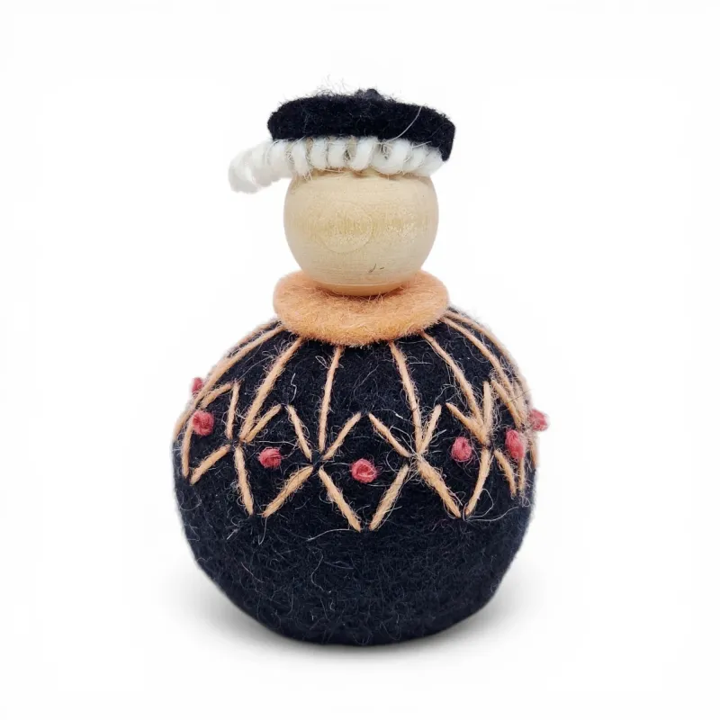 Handmade Shepherd Flóki in a patterned peach Icelandic wool sweater and a hat. Icelandic souvenir and gift