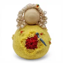 Handmade wool Crochet Lady Flóki wearing yellow dress holding a crochet needle. Iceland souvenir & gift.