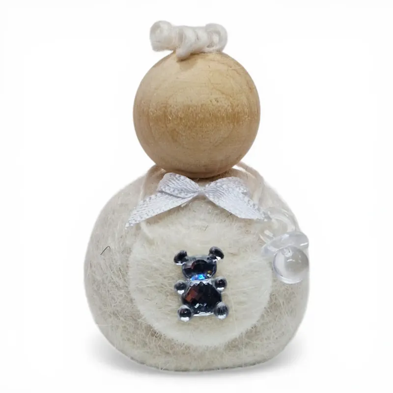 Handmade white wool boy Flóki child wearing bib apron with teddy bear. Icelandic souvenir and gift.