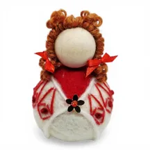 Handmade wool Summer Girl Flóki wearing red wool sweater with matching hair bow. Icelandic souvenir and gift