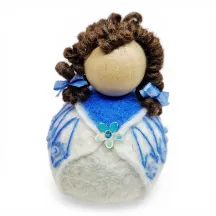 Handmade wool Summer Girl Flóki wearing light blue wool sweater with matching hair bow. Icelandic souvenir and gift