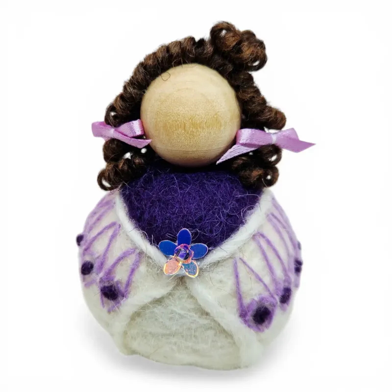 Handmade wool Summer Girl Flóki wearing purple wool sweater with matching hair bow. Icelandic souvenir and gift