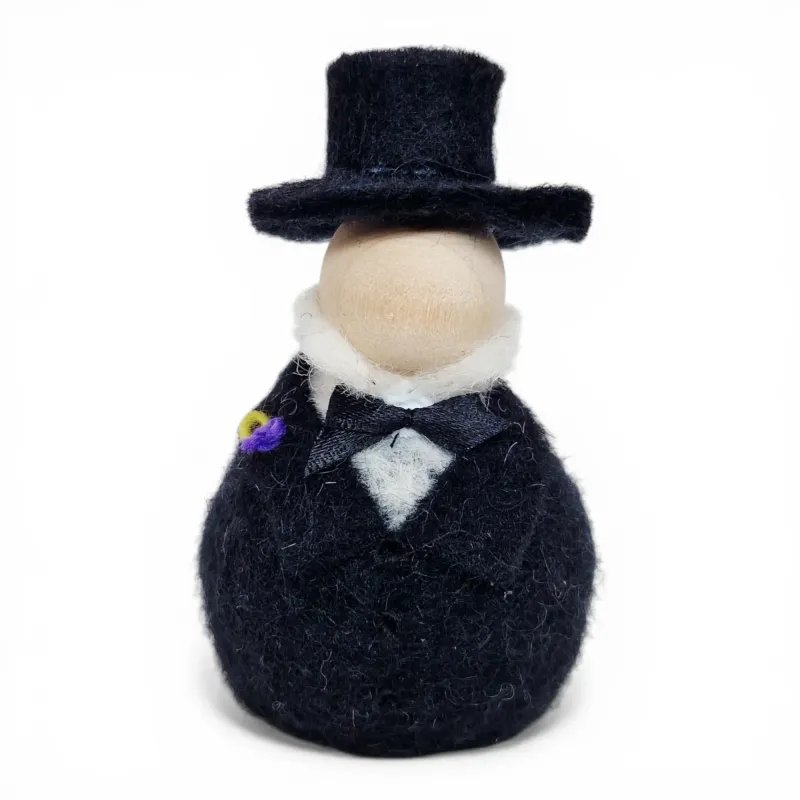 Handmade wool Bridegroom Flóki in a black suit, top hat, black bow, and purple boutonniere. Icelandic souvenir and gift