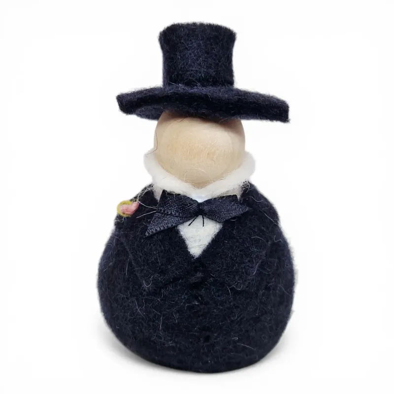 Handmade wool Bridegroom Flóki in a black suit, top hat, black bow, and light pink boutonniere. Icelandic souvenir and gift