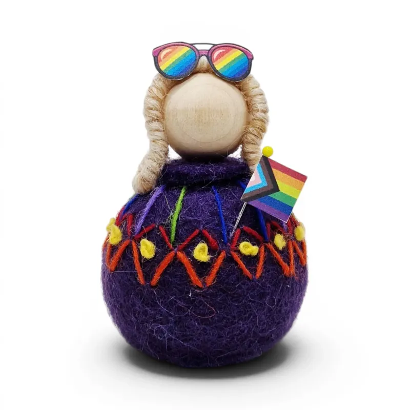 Handmade purple wool Rainbow Girl Flóki, in a decorated sweater with the progress flag. Icelandic Pride souvenir and gift